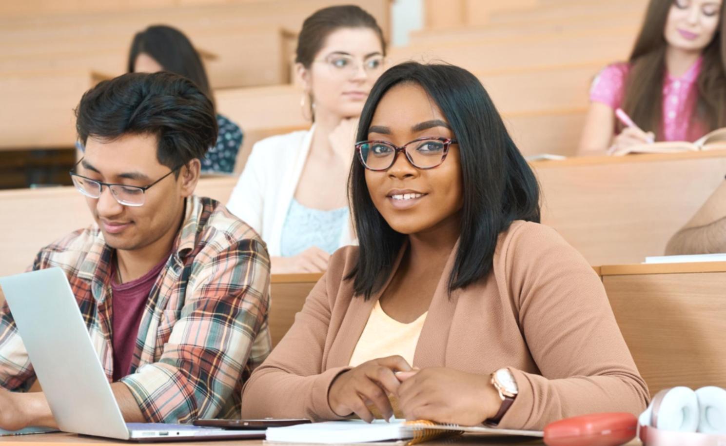 Financial analysis workspace with documents and laptop showing real-world statement review